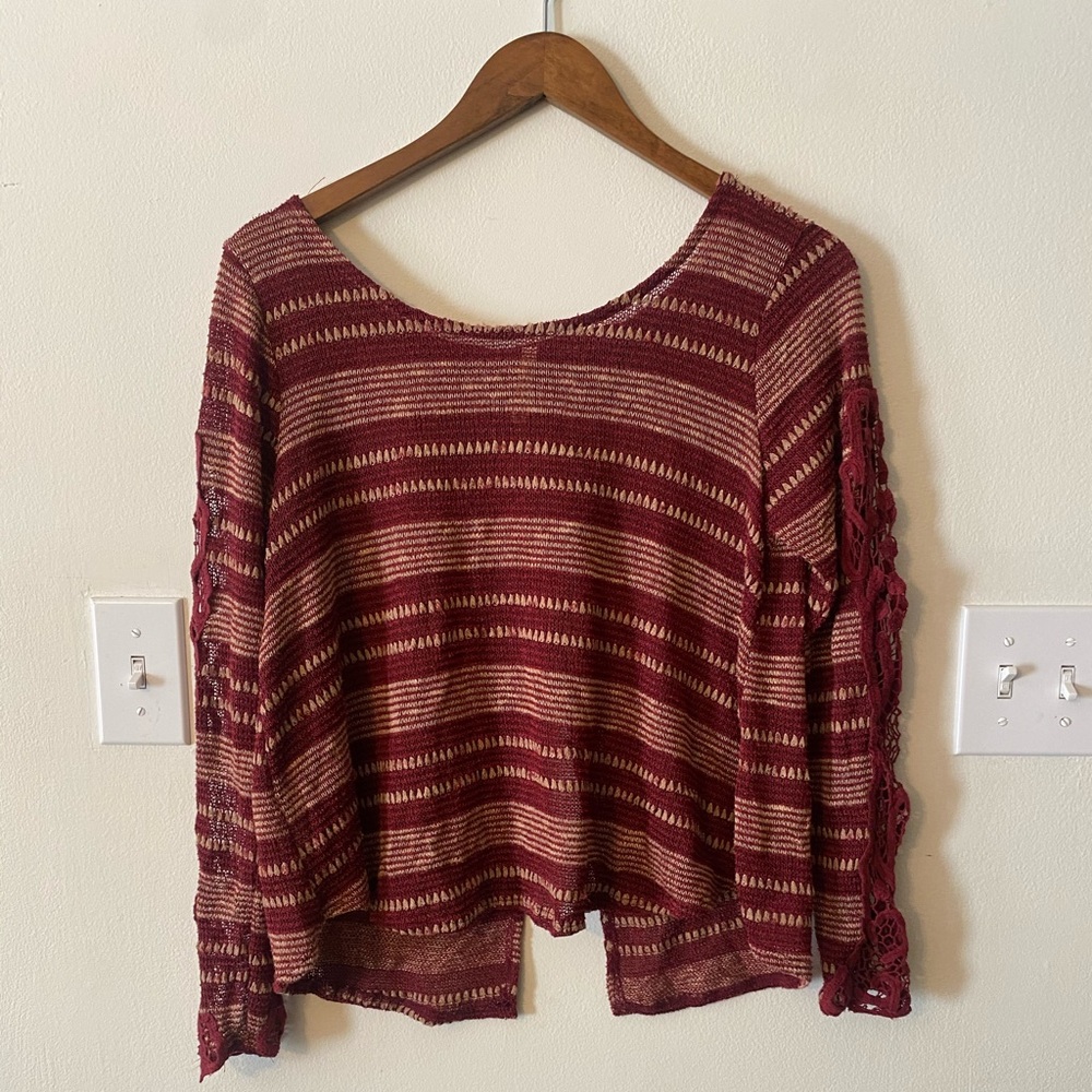 Red striped sweater with open back and lace sleeves
